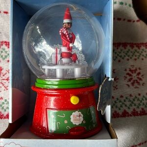 Elf on shelf snow globe